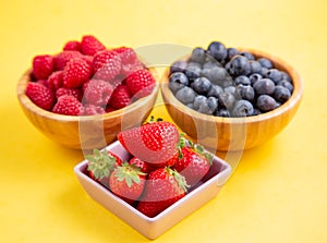 Group berry mix - strawberries, raspberries and blueberries of nature fruit in wood bowl, healthy food for diet