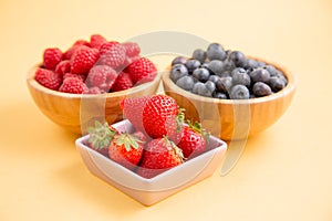 Group berry mix - strawberries, raspberries and blueberries of nature fruit in wood bowl, healthy food for diet