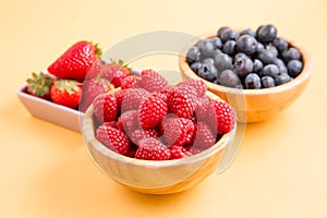 Group berry mix - strawberries, raspberries and blueberries of nature fruit in wood bowl, healthy food for diet