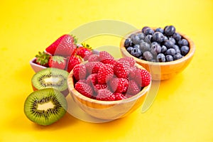 Group berry mix - strawberries, raspberries and blueberries of nature fruit in wood bowl, healthy food for diet