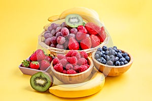 Group berry mix - strawberries, raspberries and blueberries of nature fruit in wood bowl, healthy food for diet