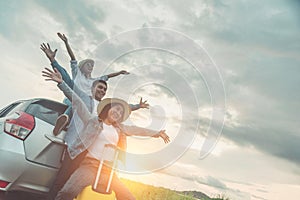 Group of best friends cheering on car road trip at sunset - Happy people outdoor on vacation tour adventure - Friendship concept