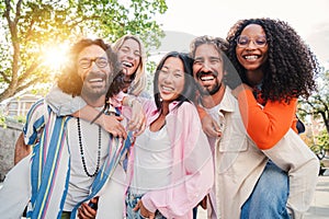 Group of best friends having fun, laughing and smiling taking a selfie portrait outside. Young adult international