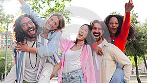Group of best friends having fun, laughing and smiling taking a selfie portrait outside. Young adult international