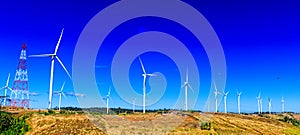Group of big wind turbines for electric generator in high hills with clear blu sky in background. Concept of clean and eco-