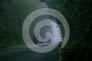 group of biker riding on foggy mountain road at khaoyai national park one of most popular traveling destination in thailand