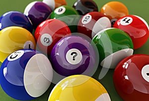 Group of billiard balls with numbers, on green carpet table.