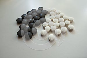 Group of black iron and white vitamin K pills