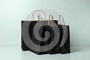 Group of black paper bags on white background