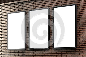 Group of blank lightboxes or street LCD panel on brown brick wall