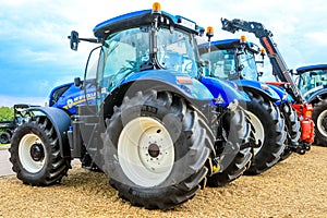 A group of blue tractors parked up