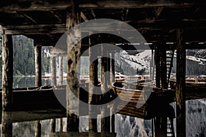 group of boasts under the abandoned hut on Braies Lake in Dolomites,South Tirol,Italy, Europe