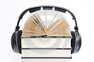 Group of books and headphones related to audiobooks on isolated