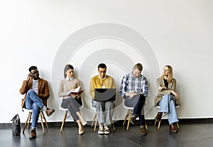 Group of bored people waiting for the job interview