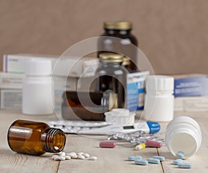 A group of boxes of medicines, pill bottles, thermometer and blisters of pills