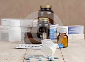 A group of boxes of medicines, pill bottles, thermometer and blisters of pills