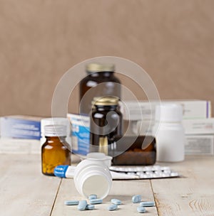 A group of boxes of medicines, pill bottles, thermometer and blisters of pills