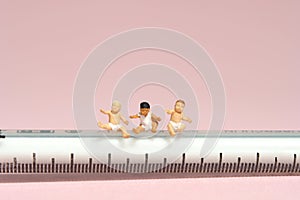 Group of boy toddler infant baby seat above needle syringe whimpering