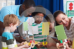 Group Of Boys Carrying Out Experiment In Science Class