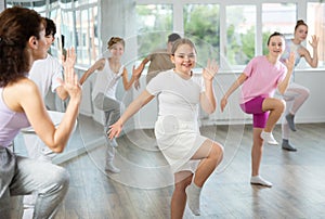 Group of boys and girls dancing dancehall