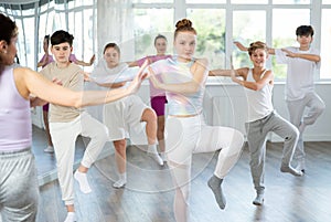 Group of boys and girls dancing dancehall photo