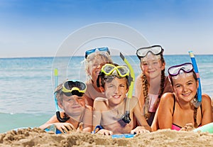 Group of boys and girls la on the sea beach