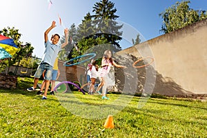 Group of boys, girls play game throw hula rings