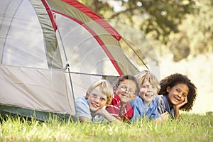 Group Of Boys Having Fun In Tent In Countryside