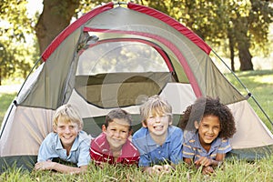 Group Of Boys Having Fun In Tent In Countryside