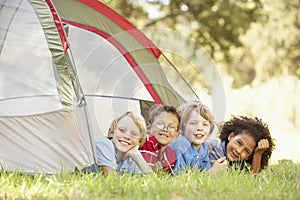 Group Of Boys Having Fun In Tent In Countryside