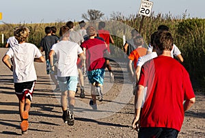 Group of boys running on dirt road by The Fire Island Lighthouse