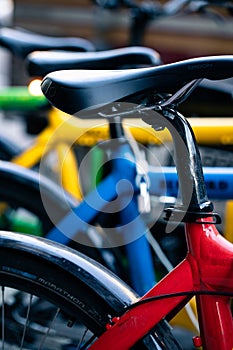 Group of bright rainbow colored bikes lined up in New York city