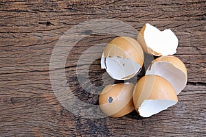 Group of broken egg shells on wooden background.