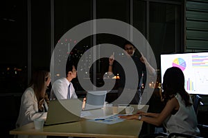 Group of broker international stock traders working actively at night in office,