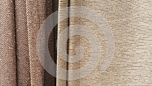 Group of brown fabric roll selection / stock of grey fabric for fashion design business
