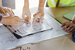Group of builder team planning and discussing construction home drawing