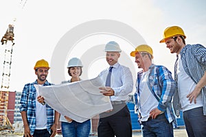 Group of builders and architects with blueprint