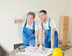 Group of builders with blueprint