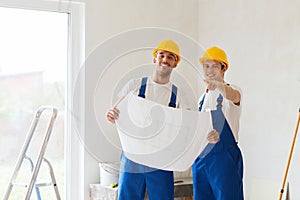 Group of builders with blueprint