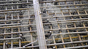 A group of builders poured concrete. The foundation of a large construction site, the builders are building a skyscraper