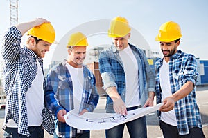 Group of builders with tablet pc and blueprint