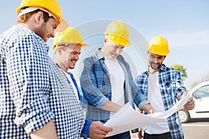 Group of builders with tablet pc and blueprint