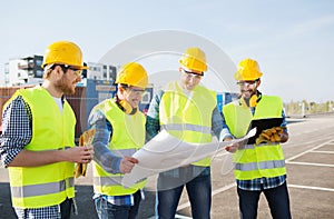 Group of builders with tablet pc and blueprint