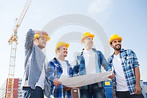 Group of builders with tablet pc and blueprint