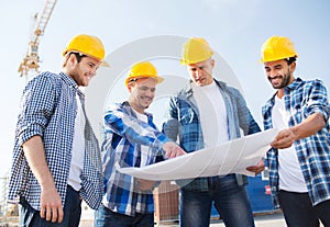 Group of builders with tablet pc and blueprint