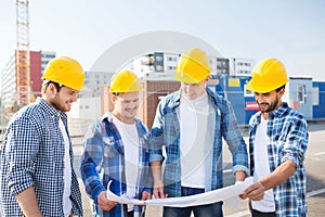 Group of builders with tablet pc and blueprint