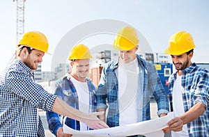 Group of builders with tablet pc and blueprint