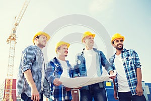 Group of builders with tablet pc and blueprint