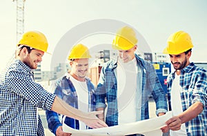 Group of builders with tablet pc and blueprint