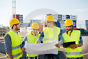 Group of builders with tablet pc and blueprint